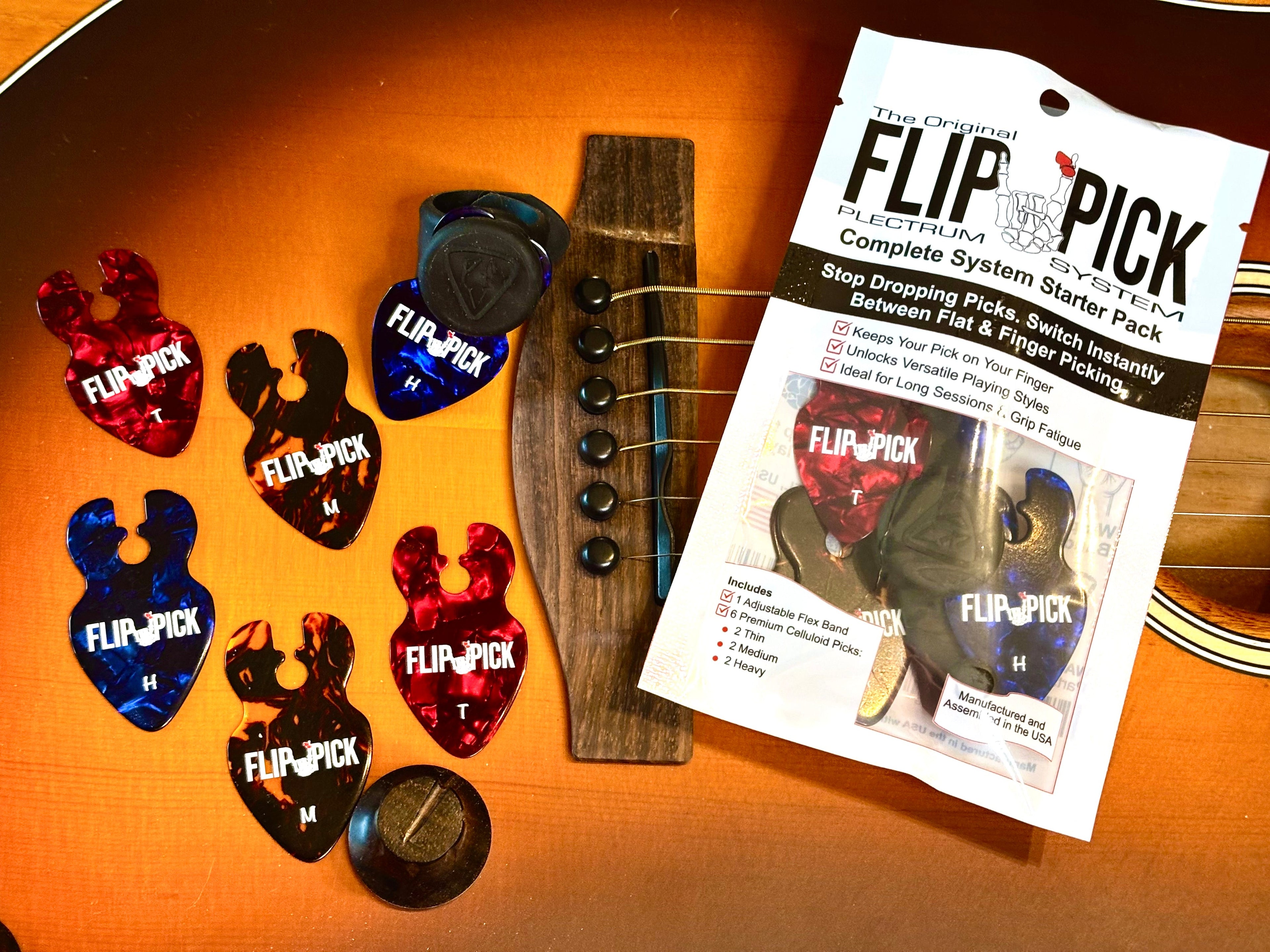 A package of Music City Made Flip-Pick guitar string winder beads and six colorful plastic guitar picks arranged on a wooden guitar headstock.